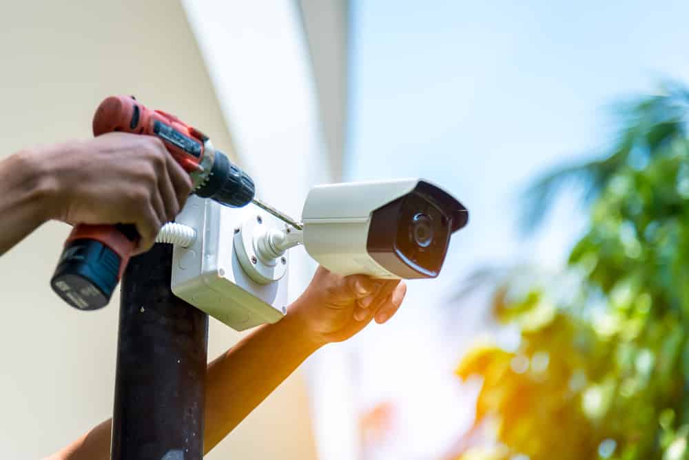 Technician installing a security camera system